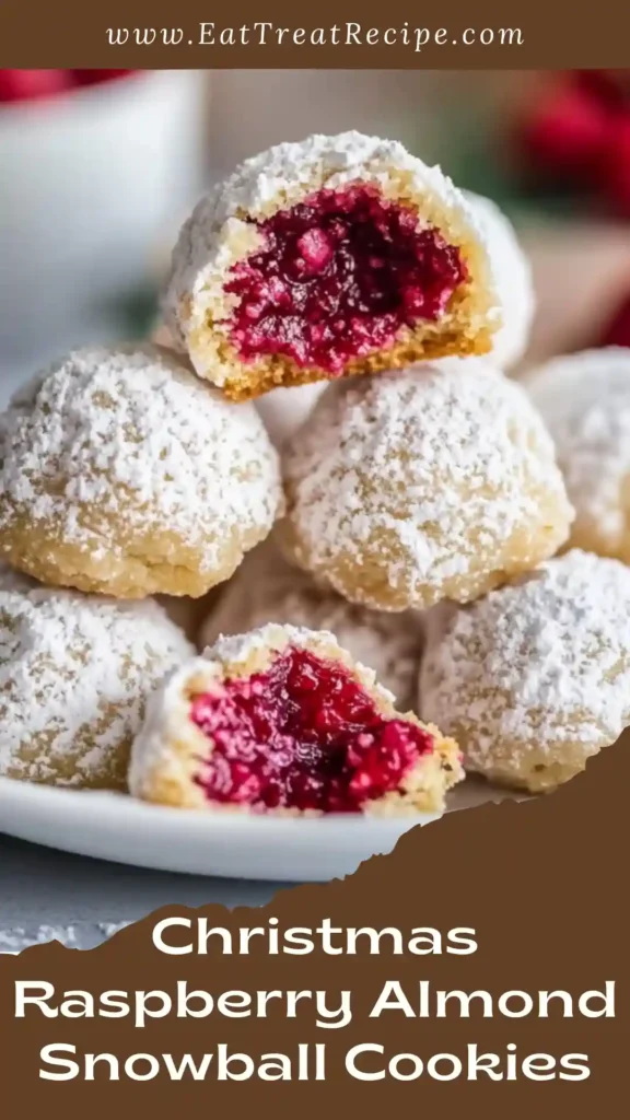 Christmas Raspberry Almond Snowball Cookies with raspberry filling and powdered sugar